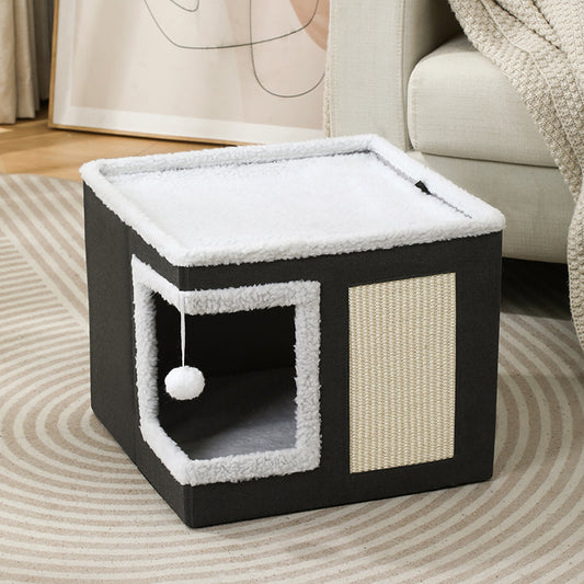 Cube pliable noir pour chat avec griffoir en sisal et jouet suspendu à pompon blanc.